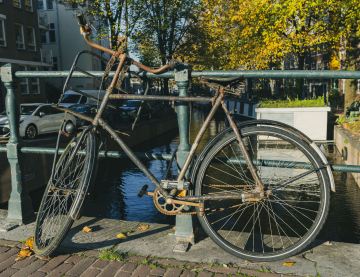 Stary Rower w Amsterdamie przypięty do barierki - zdjęcie stockowe